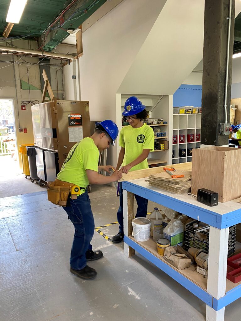 Grafton students practice peer-to-peer working on sawhorse